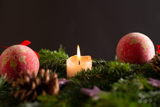 christmas decor with tree-balls, candle, branch and cone