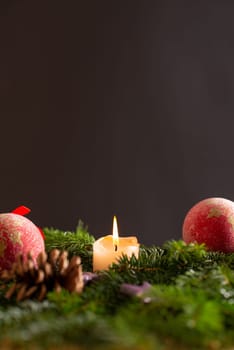 christmas decor with tree-balls, candle, branch and cone