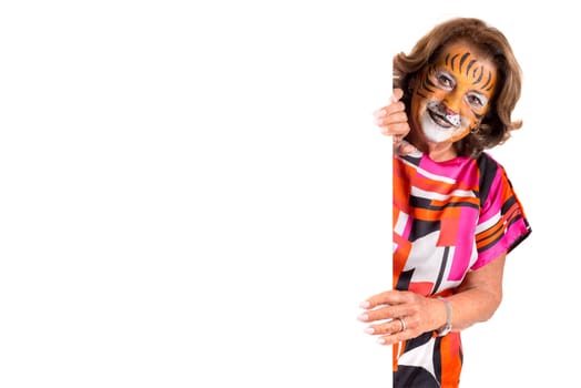 senior woman with tiger face-paint over a white board isolated in white