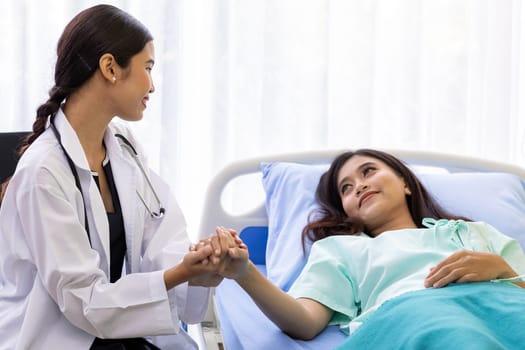 medical doctor holding patient's hands to cheer up patient