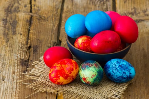 Happy Easter, colorful eggs in a bowl