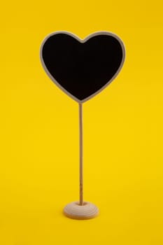 Little Chalkboard with heart shape isolated on yellow Background