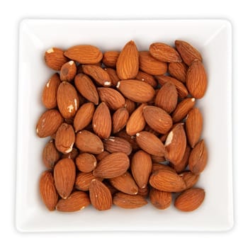 Almonds in a bowl isolated on white background
