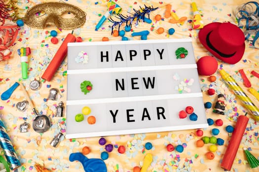 Happy New Year greetings on a lightbox with party dekoration
