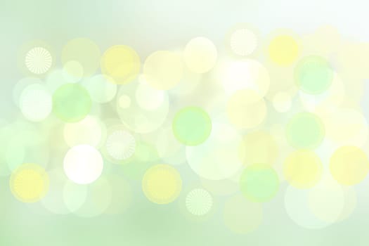 Abstract blurred light green pastel background texture with white and yellow bokeh circles.