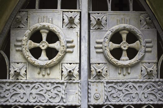 Religious crosses in metallic door and ancient religion and construction