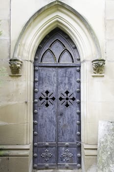 Old metal door with symbolic crosses, religion and construction