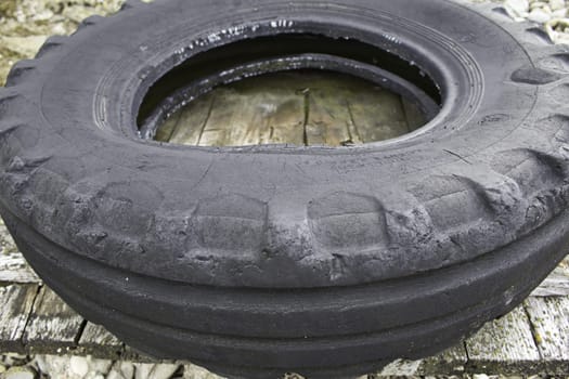 Worn wheel on wooden pallet in workshop, repair and mechanical