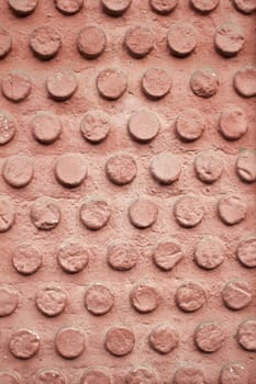 Red wall of rough circles cement, construction and architecture