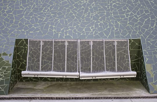 Iron metal bench inside tile structure, construction