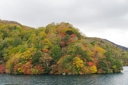 Lake Chuzenji is a scenic lake in the mountains above the town of Nikko. It is located at the foot of Mount Nantai, Nikko's sacred volcano, whose eruption blocked the valley below, thereby creating Lake Chuzenji about 20,000 years ago. This photo was shot in autumn