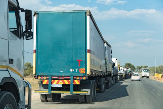 trucks are waiting for the kazungula ferry across the zambezi river, which borders botswana and zambia