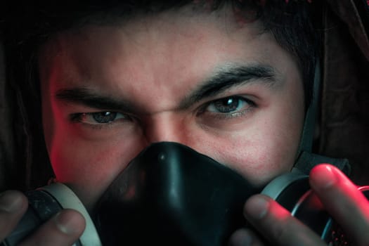 A man in a gas mask on a black background