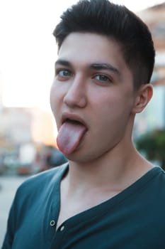 attractive young man showing his tongue