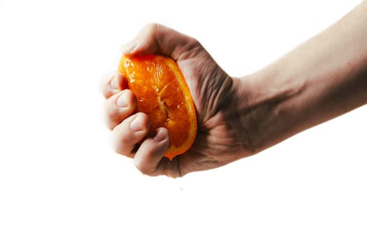man dramatic squeezes orange. Concept squeezed a man is tired from work.