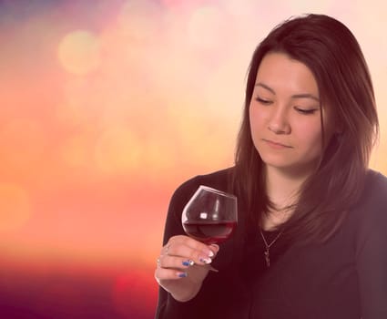 beautiful woman with glass red wine on abstract background