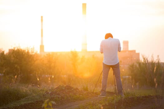 photographer shooting with sunset