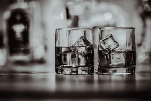 2 glasses of whiskey black and white