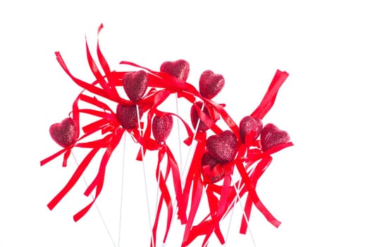 Red valentine heart shaped decorations with ribbon and bows isolated over white background.