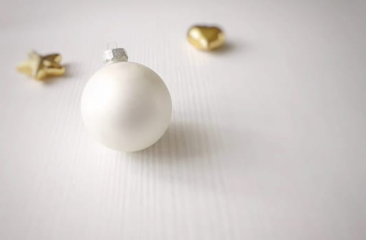 white christmas ball on a white wooden table