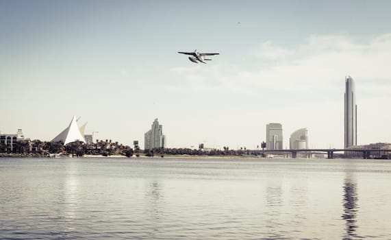 Seaplane taking off from Dubai Creek near Park Hyatt golf course
