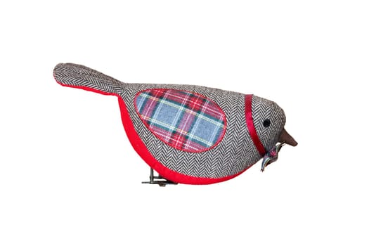Christmas decoration background. A red christmas fabric bird carries a colorful bow tie and is isolated on a white background.