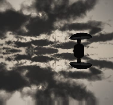 Man with umbrella in clouds. Black and white picture.