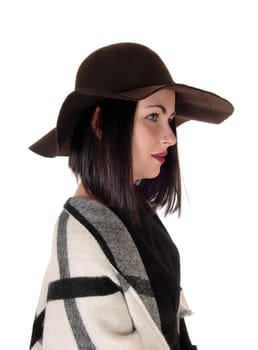 A closeup image of a beautiful woman in a black dress and hat and a big.poncho over her shoulder, isolated for white background.