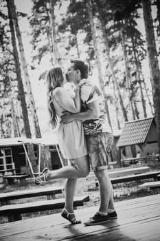 Black white photography romantic young couple kissing on background summer forest