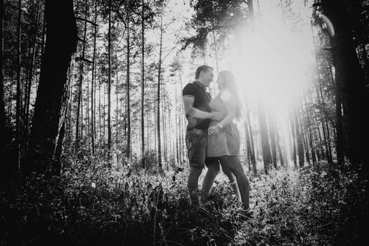 Black white photography romantic young couple kissing on background summer forest