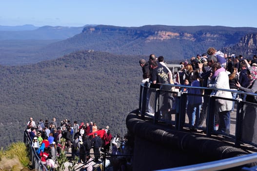 Katoomba, Australia - August 13, 2017: Tourists taking pictures at Blue Mountain National Park Three Sisters lookout view point in Katoomba Town, Sydney, New South Wales, Australia.