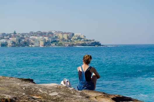 young woman against the blue sea