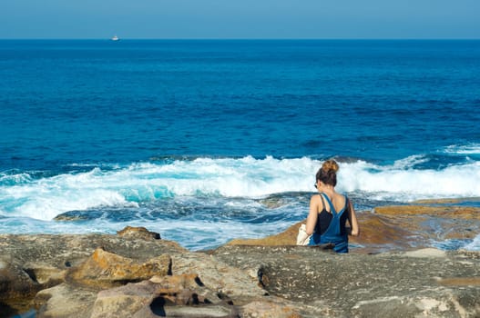 young woman against the blue sea