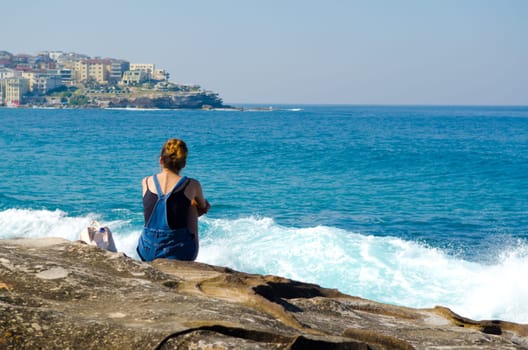 young woman against the blue sea