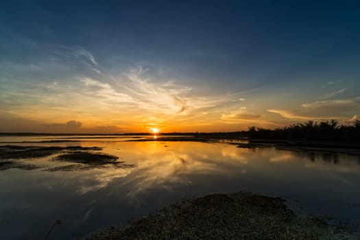 Lake with sunset reflection, tranquil landscape with standing water
