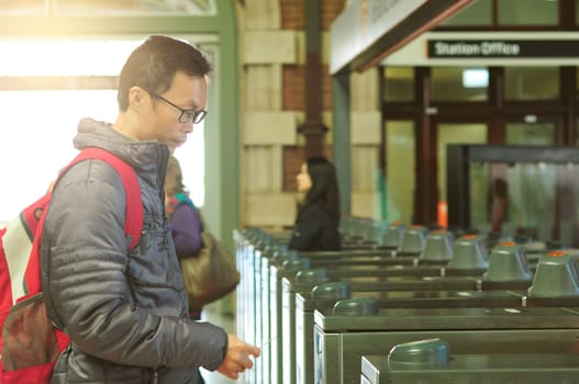Passengers using entering the automatic ticket gates at Central railway station, Sydney, Australia