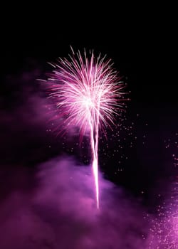 Fireworks display over dark sky