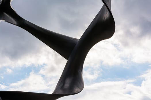 Abstract Curving Sculpture Statue on Blue Sky Architecture Contemporary Modern Art