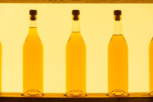 Abstract Yellow Clear Glass Bottles Shelf Backlit