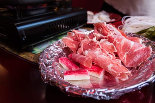 Aluminum Foil Plate Bowl Raw Meat Beef Pieces Collection Chinese Hot Pot Sharing Food Eating Restaurant Table Red White Detail Closeup