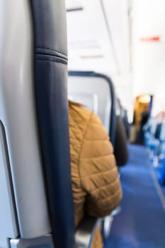 Airplane Headrest Seat Behind Isle Depth of Field Bokeh Blue Leather Texture