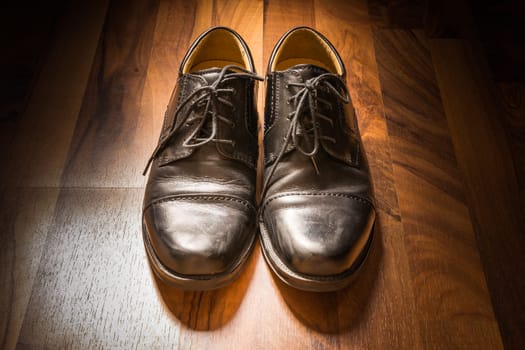 Black Leather Dress Shoes Worn Wooden Floor Sunlight Spotlight Sheen Elegenat Business Casual