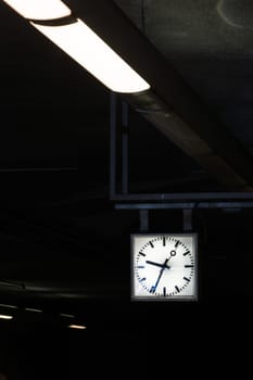 Contrast Diagonal Flourescent Lights Leading to Square Geometric Clock Time Architecture