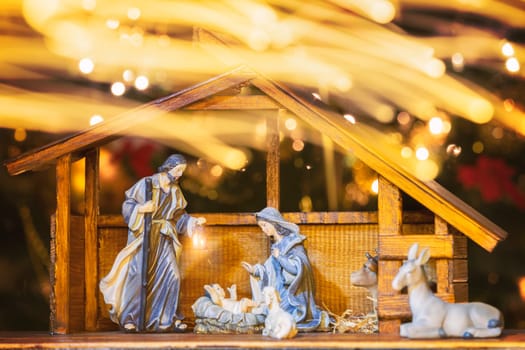 Christmas Manger scene with figurines including Jesus, Mary, Joseph and sheep. Focus on mother!