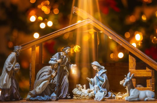 Christmas Manger scene with figurines including Jesus, Mary, Joseph, sheep and wise men. Focus on baby!