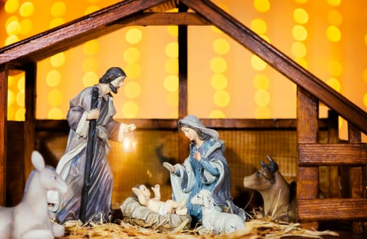 Christmas Manger scene with figurines including Jesus, Mary, Joseph and sheep. Focus on mother!