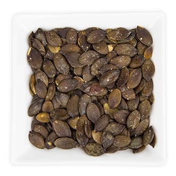 Pumpkin Seeds in a bowl isolated on white background