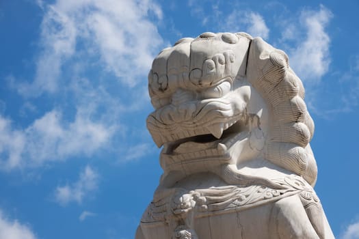 Chinese Lion marble, buddhist figurine with blue sky