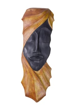 Interior decorations. A carved wooden face of a woman from cuba isolated on a white background.