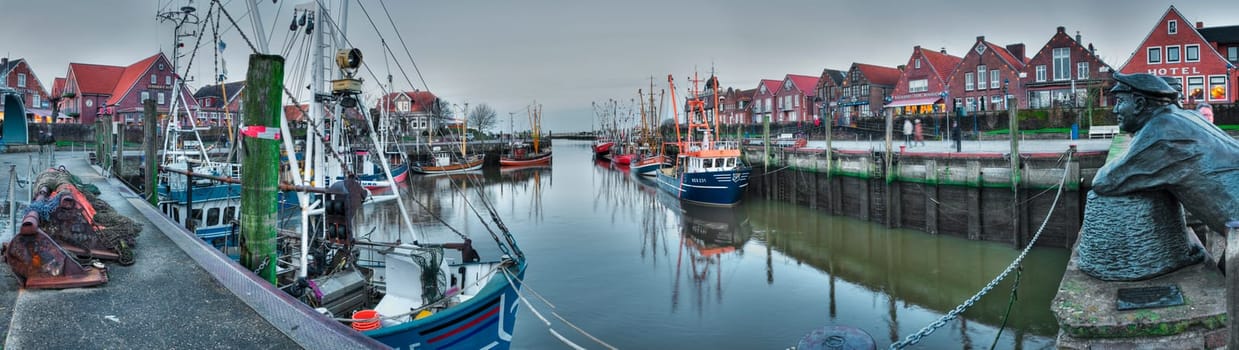 Neuharlingersiel,Germany - January 1,2014: Panoramic view of the port of Neuharlingersiel in the evening-dawn